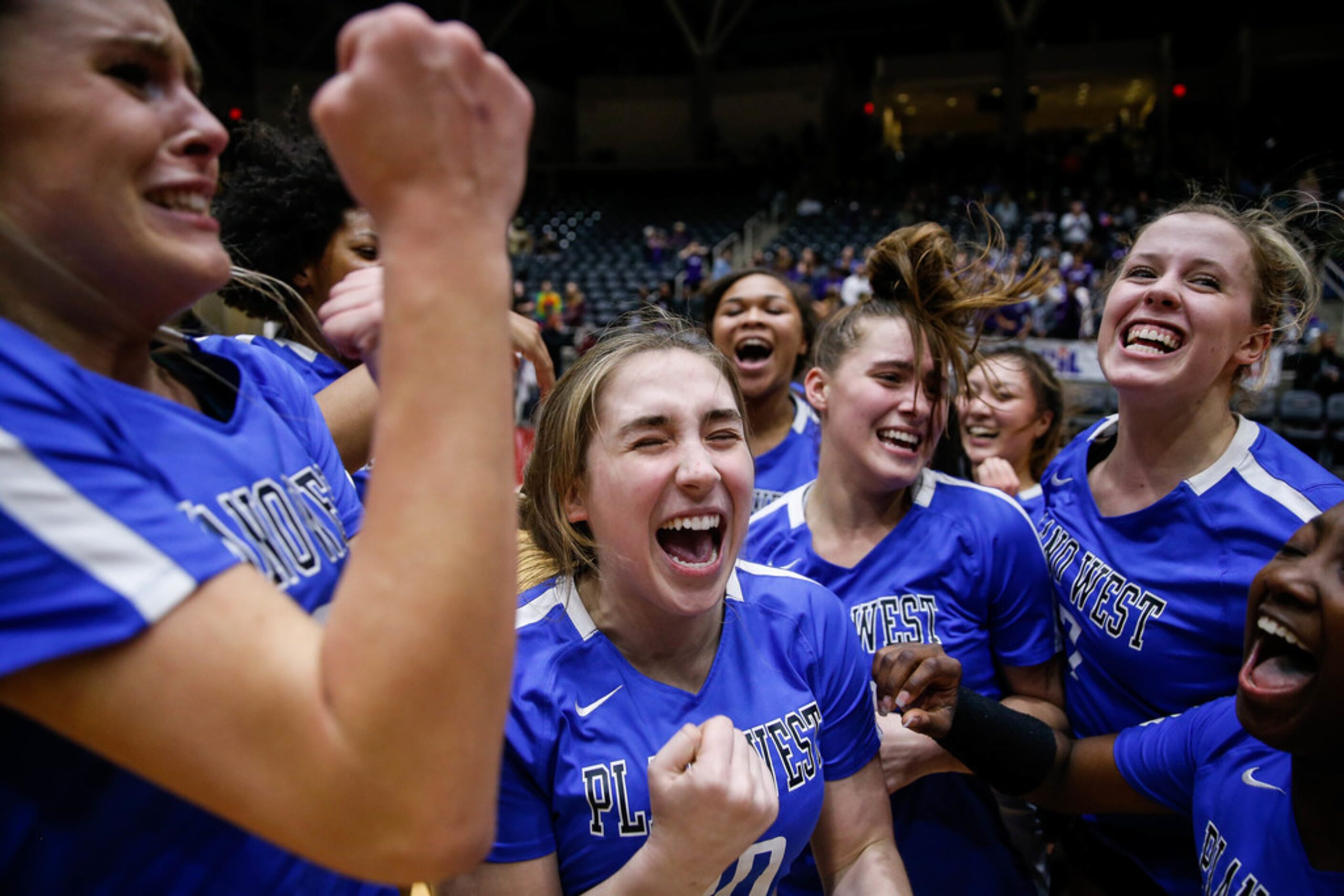 The Plano West Wolves celebrate after winning the fifth and final set during a class 6A...