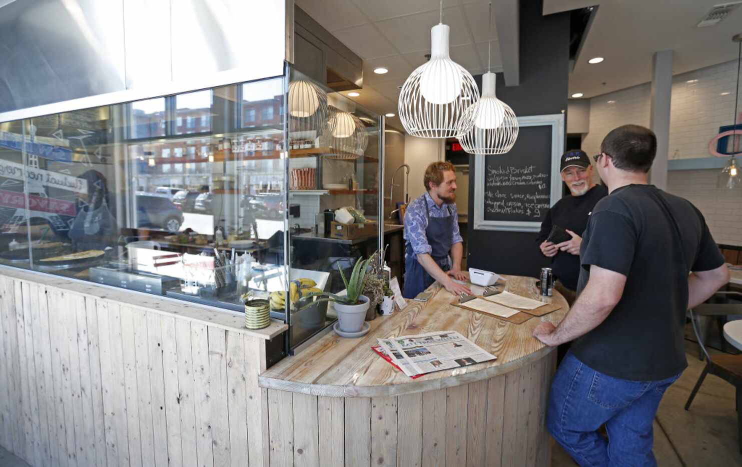 Chef-owner Julien Eelsen, left, with customers at Whisk Crepes Cafe 