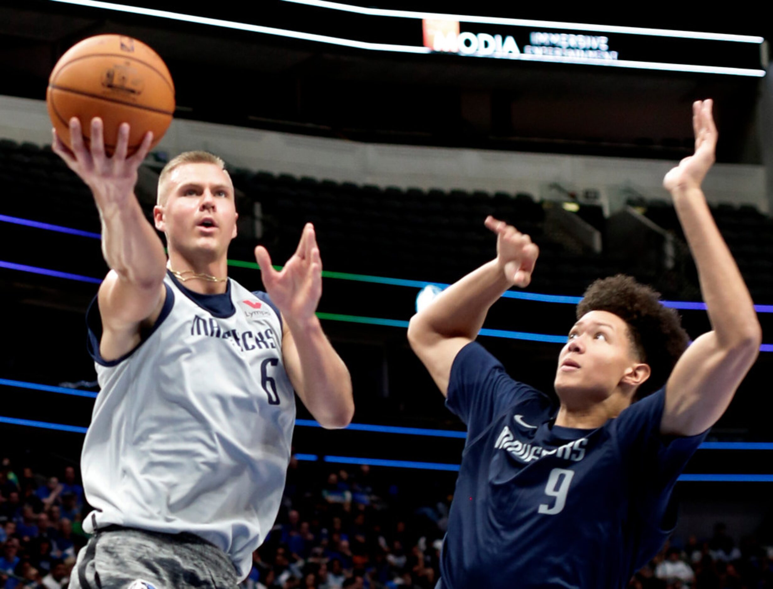 Dallas Mavericks center Kristaps Porzingis (6) drives to the basket past forward Isaiah Roby...