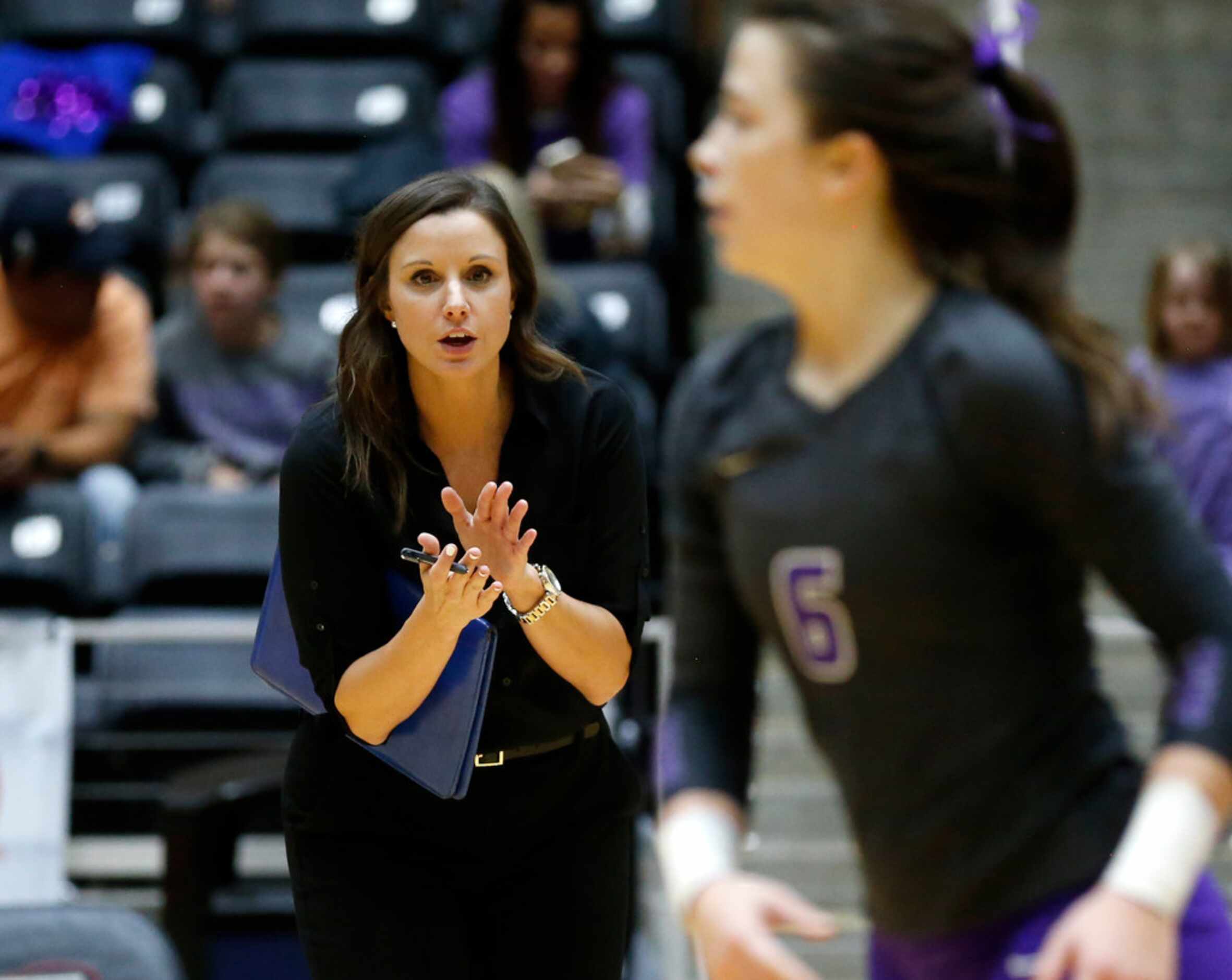 Lamar Fulshear's head coach Sydney Gotcher cheers on Bridget Barton (6) from the sidelines...