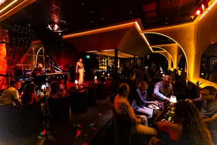Lounge seating surrounds a stage at Regines, a speakeasy.