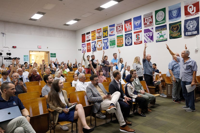 Tom Smith, who lives in Uptown McKinney Avenue area, far right, asks whoever opposes the...