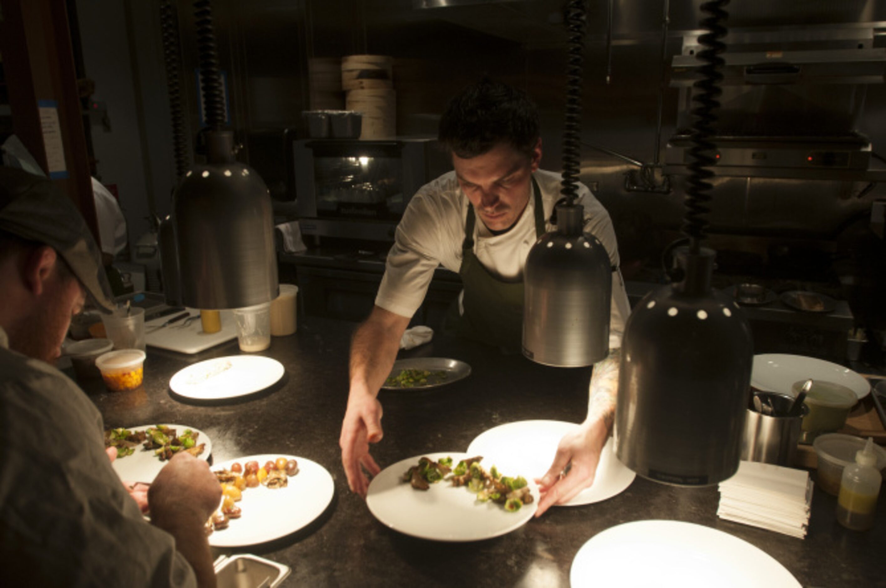 Matt McCallister working in the open kitchen of his new restaurant, FT33, in the Design...