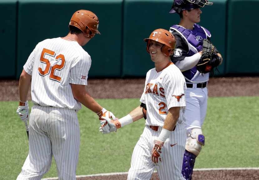 Texas' Kody Clemens (2) celebrates with teammate Zach Zubia (52) after he hit a solo home...