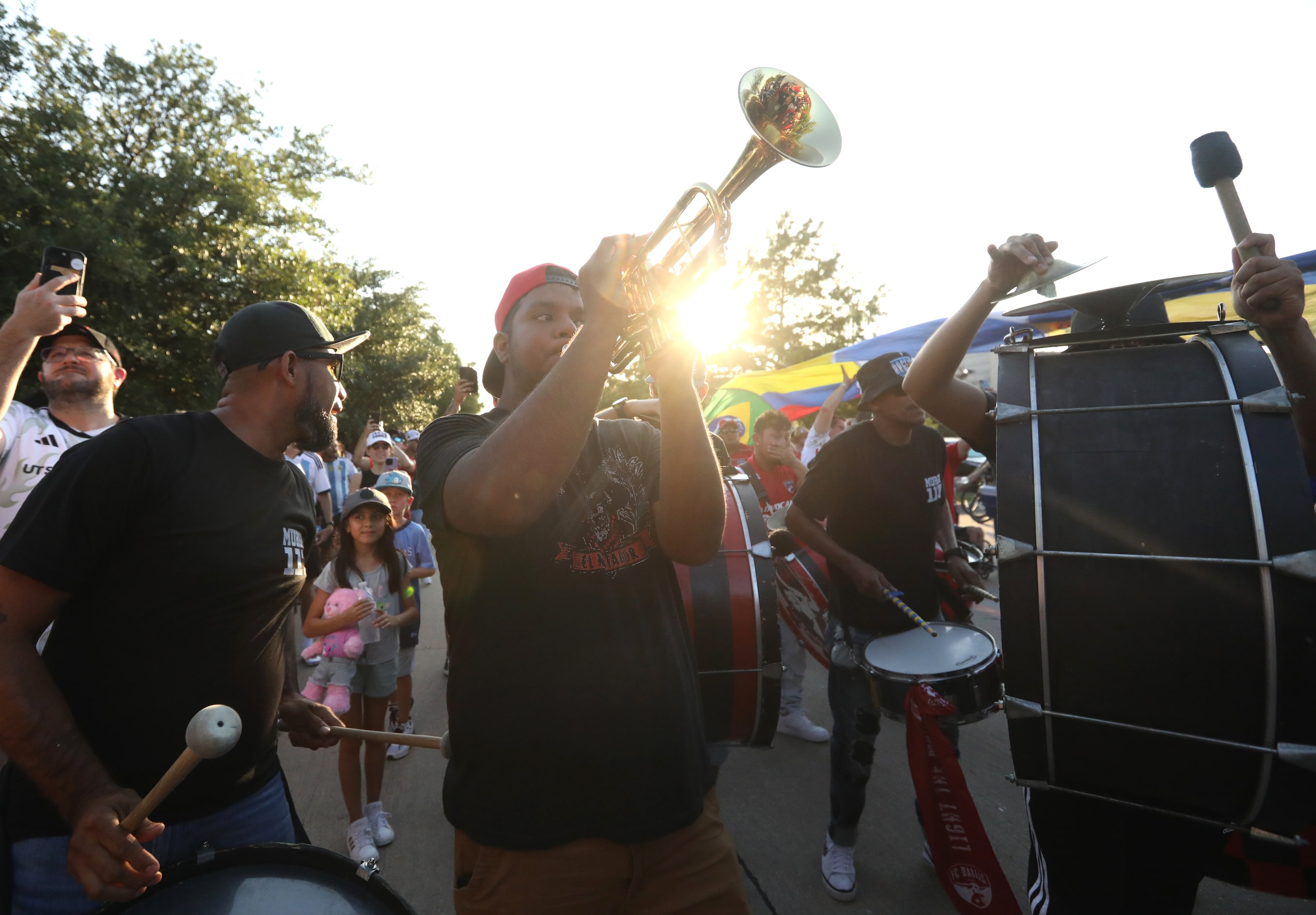 Fans join a parade as the gates to open for an FC Dallas game at Toyota Stadium in Frisco,...