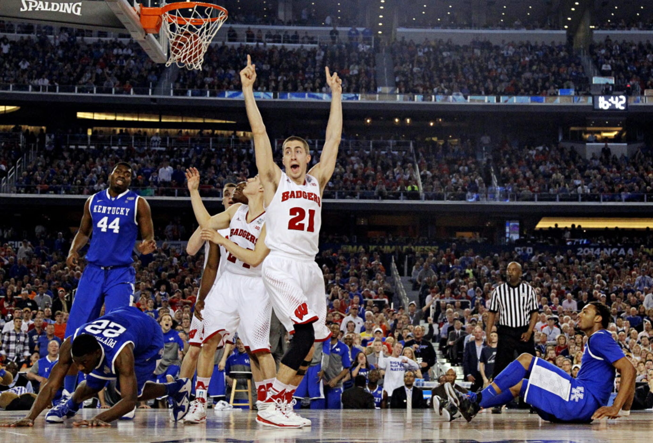 Wisconsin Badgers guard Josh Gasser (21) argues with an official as a basket by Kentucky...