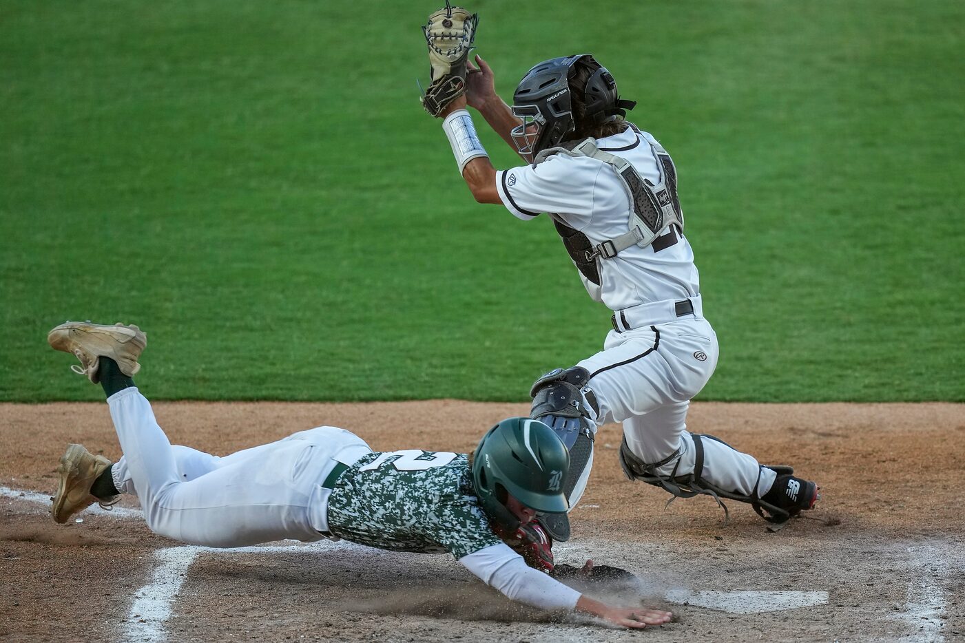 San Antonio Reagan infielder Cole Tabor (2) scores ahead of the tag from Rockall-Heath...