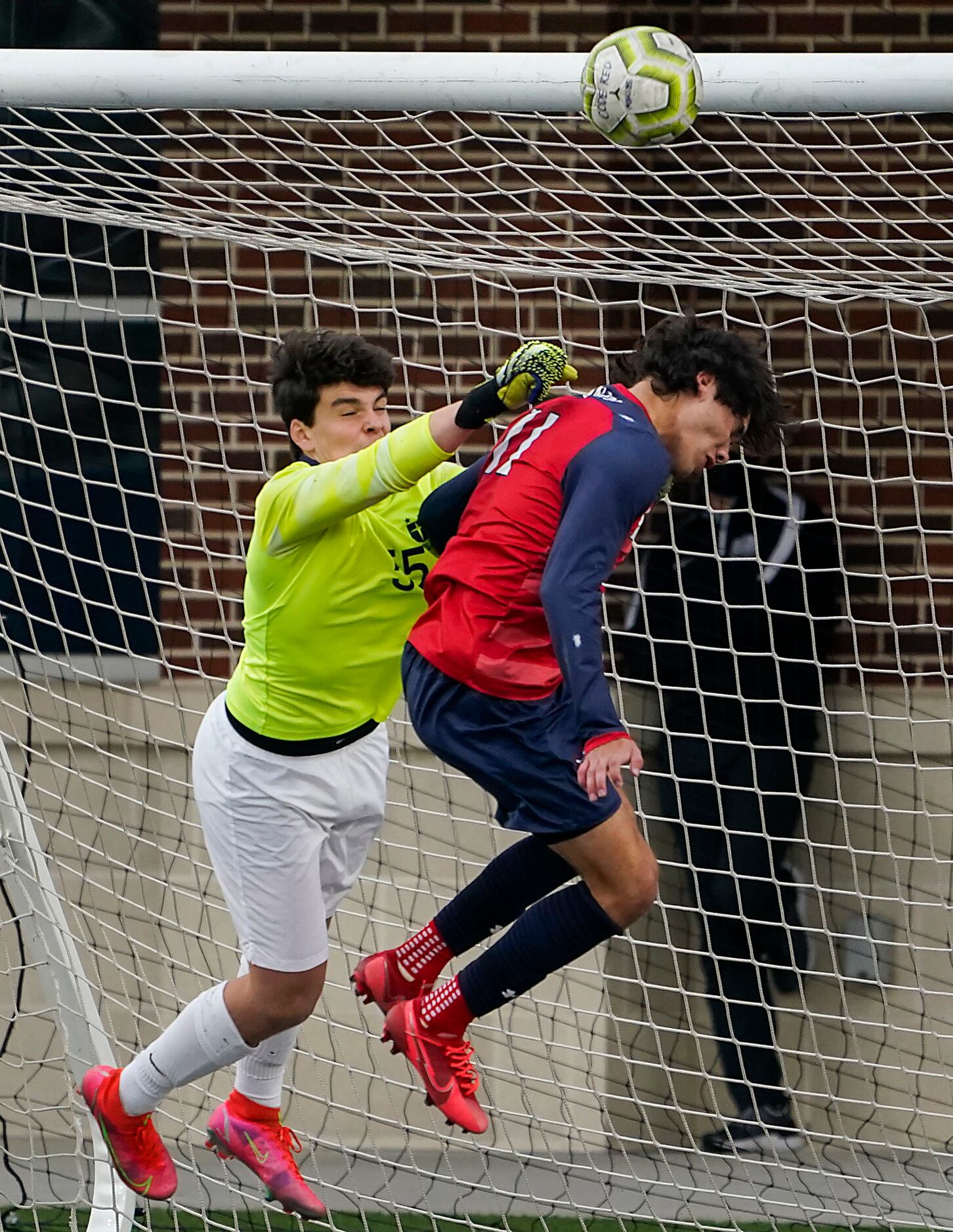 Jesuit goalkeeper Cole Hines (55) punches the ball away from McKinney Boyd forward Jonathan...