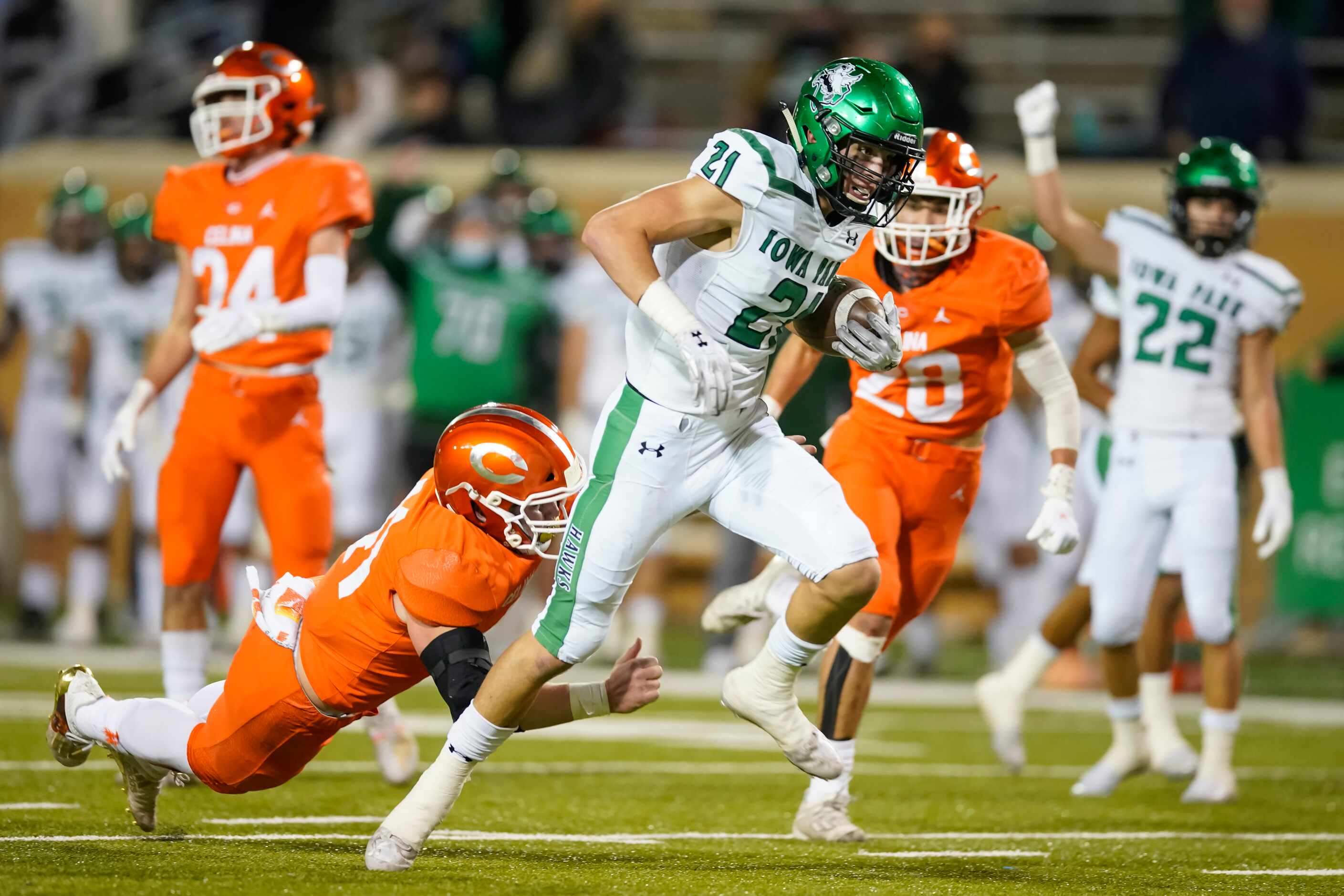 Iowa Park wide receiver Ty Cunningham (21) gets past Celina linebackerf Hunter Neely (41)...