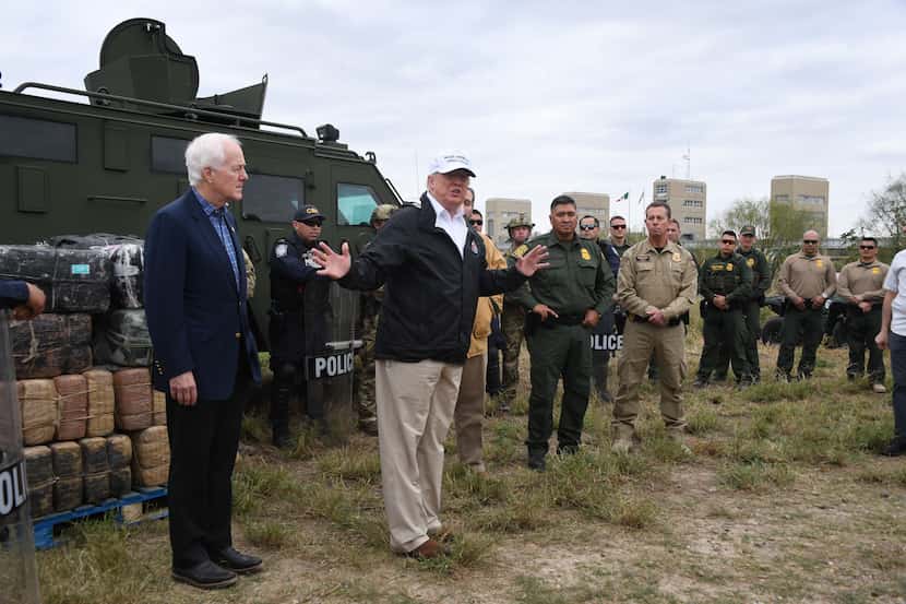 President Donald Trump speaks with Border Patrol agents next to Sen. John Cornyn near the...