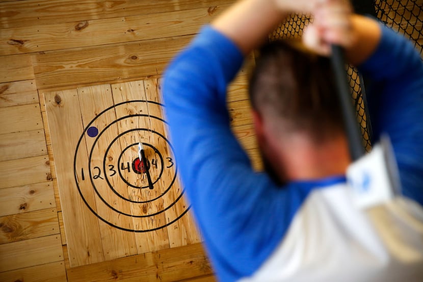 Anthony McGacock, operations manager, demonstrates ax throwing at Bad Axe Throwing in Dallas...