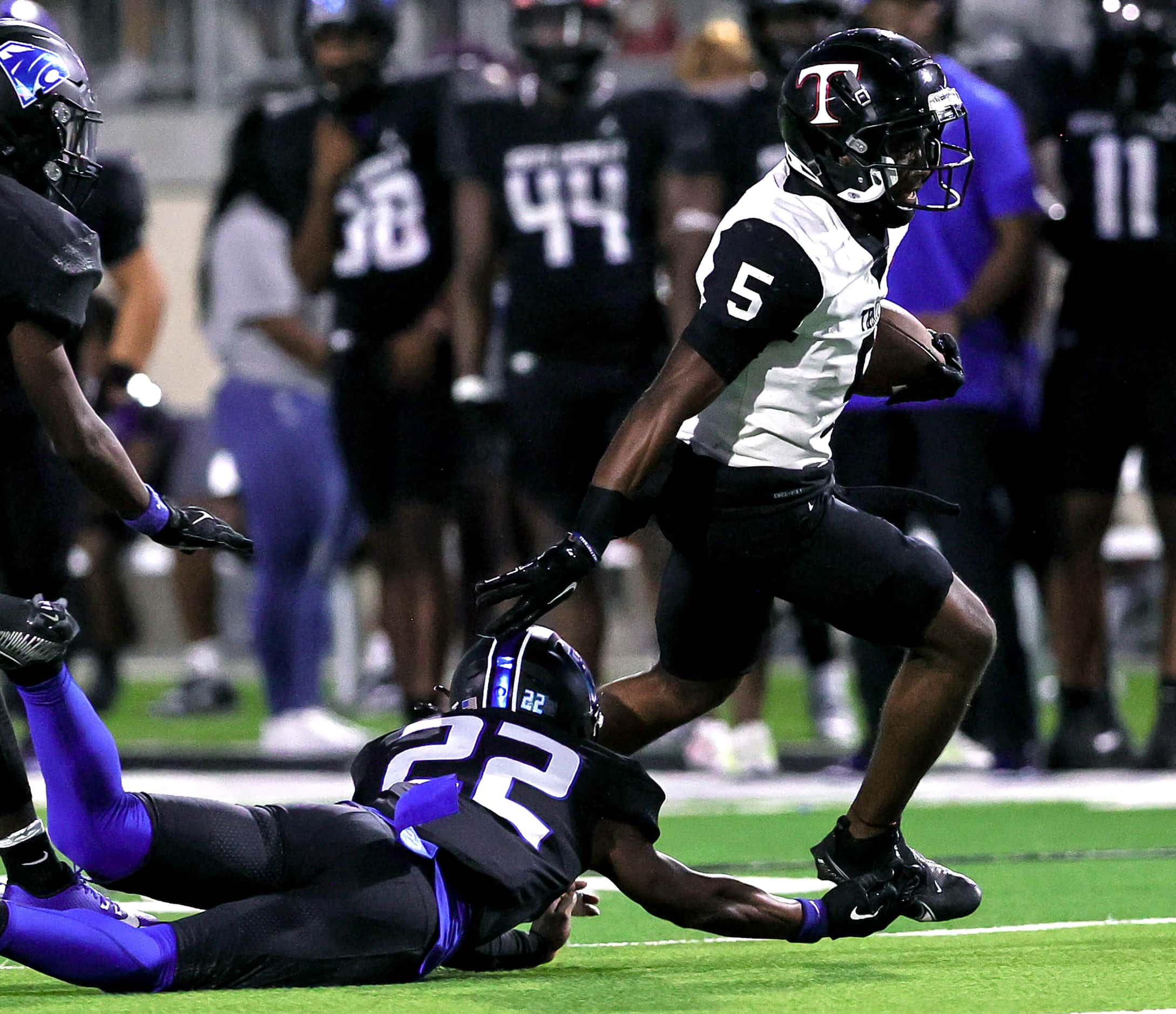 Euless Trinity running back Ethan Wright (5) avoids getting tackled by North Crowley...