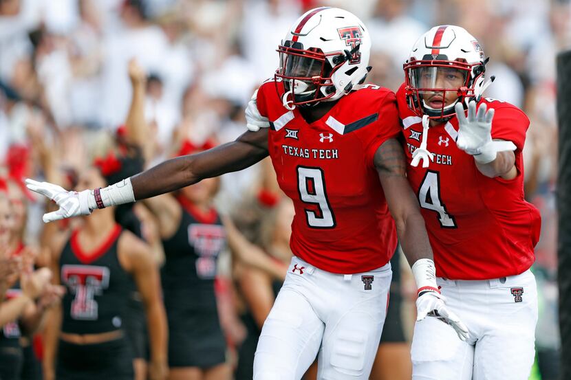 Texas Tech's T.J. Vasher (9) celebrates with Antoine Wesley (4) after scoring a touchdown...