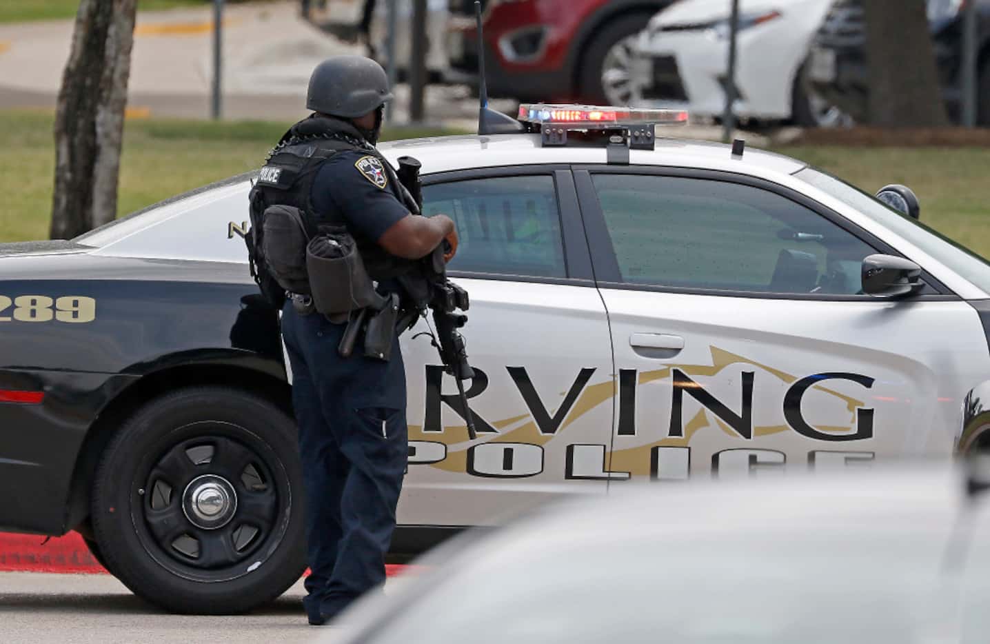 An Irving police officer works at the shooting scene on the North Lake College campus in...