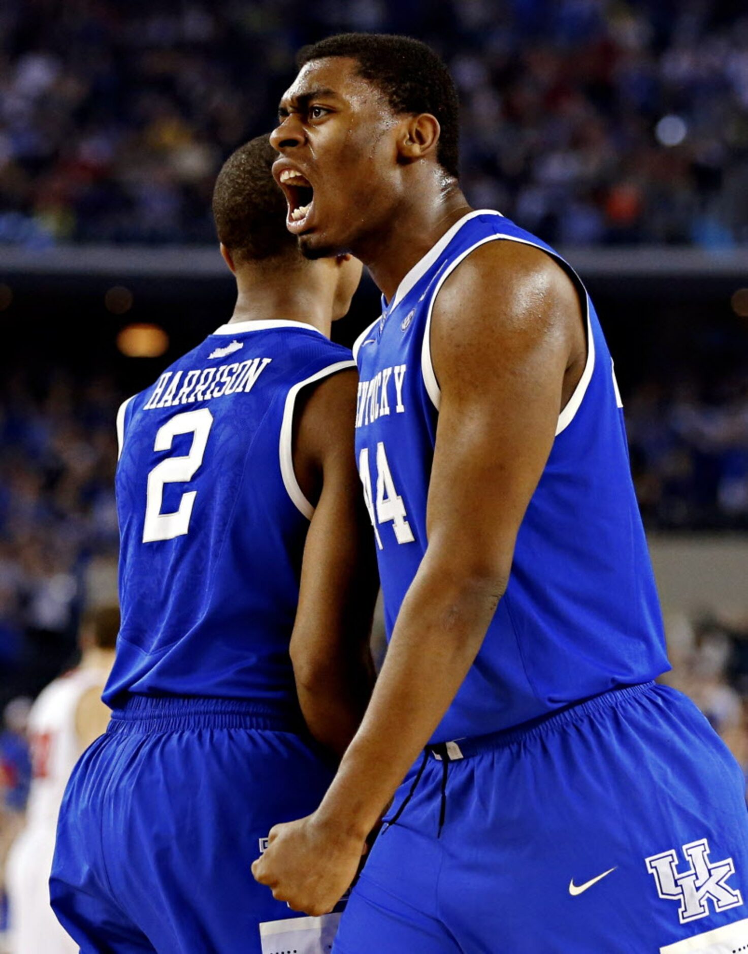 Kentucky Wildcats center Dakari Johnson (22) and guard Aaron Harrison react during the...