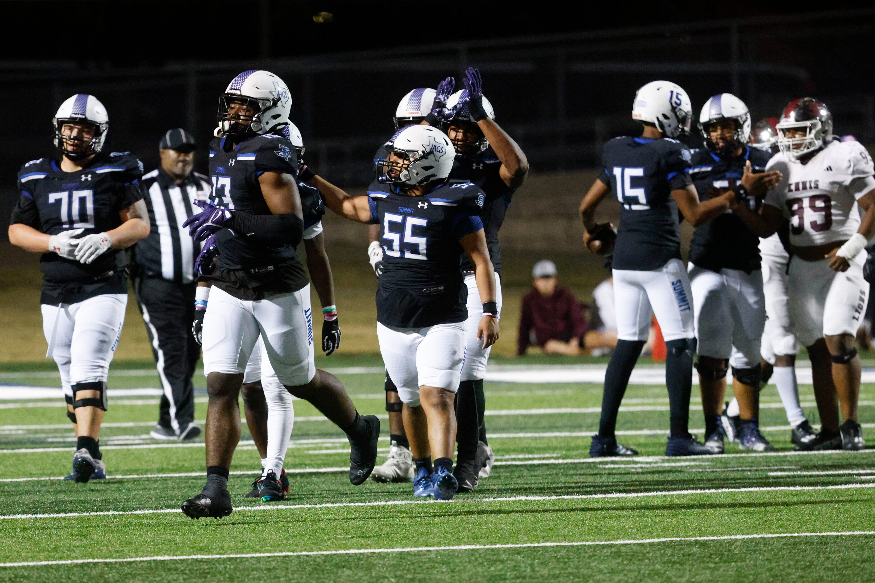 Mansfield Summit High players exit the field after winning against Ennis High during a...