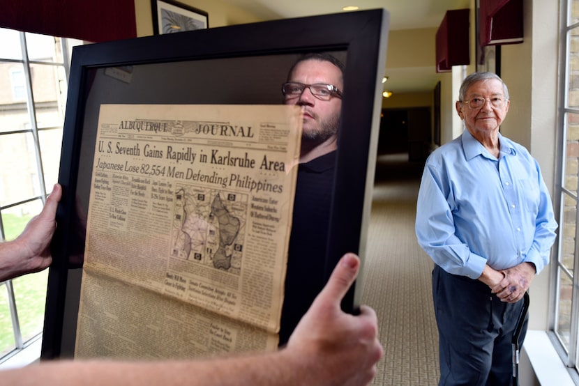 Will Williford, director of sales and marketing, left, is seen in the reflection of a glass...