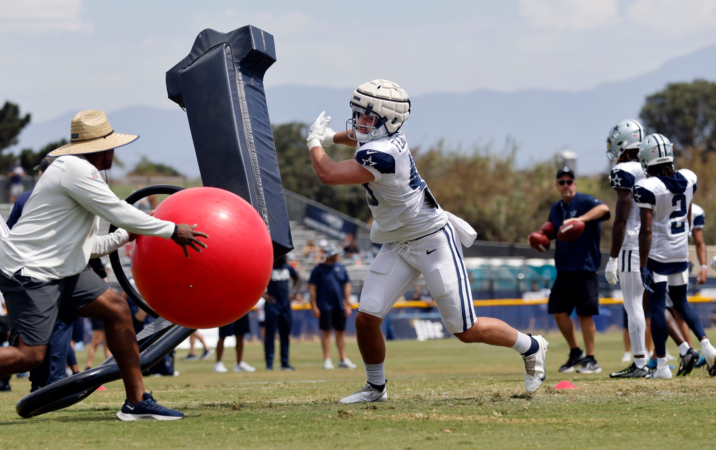 Dallas Cowboys tight end Jake Ferguson (48) pushes off the blocking sled before catching a...