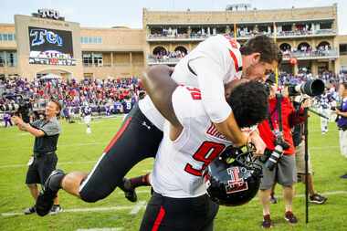 Texas Tech place kicker Clayton Hatfield celebrates with defensive lineman Broderick...