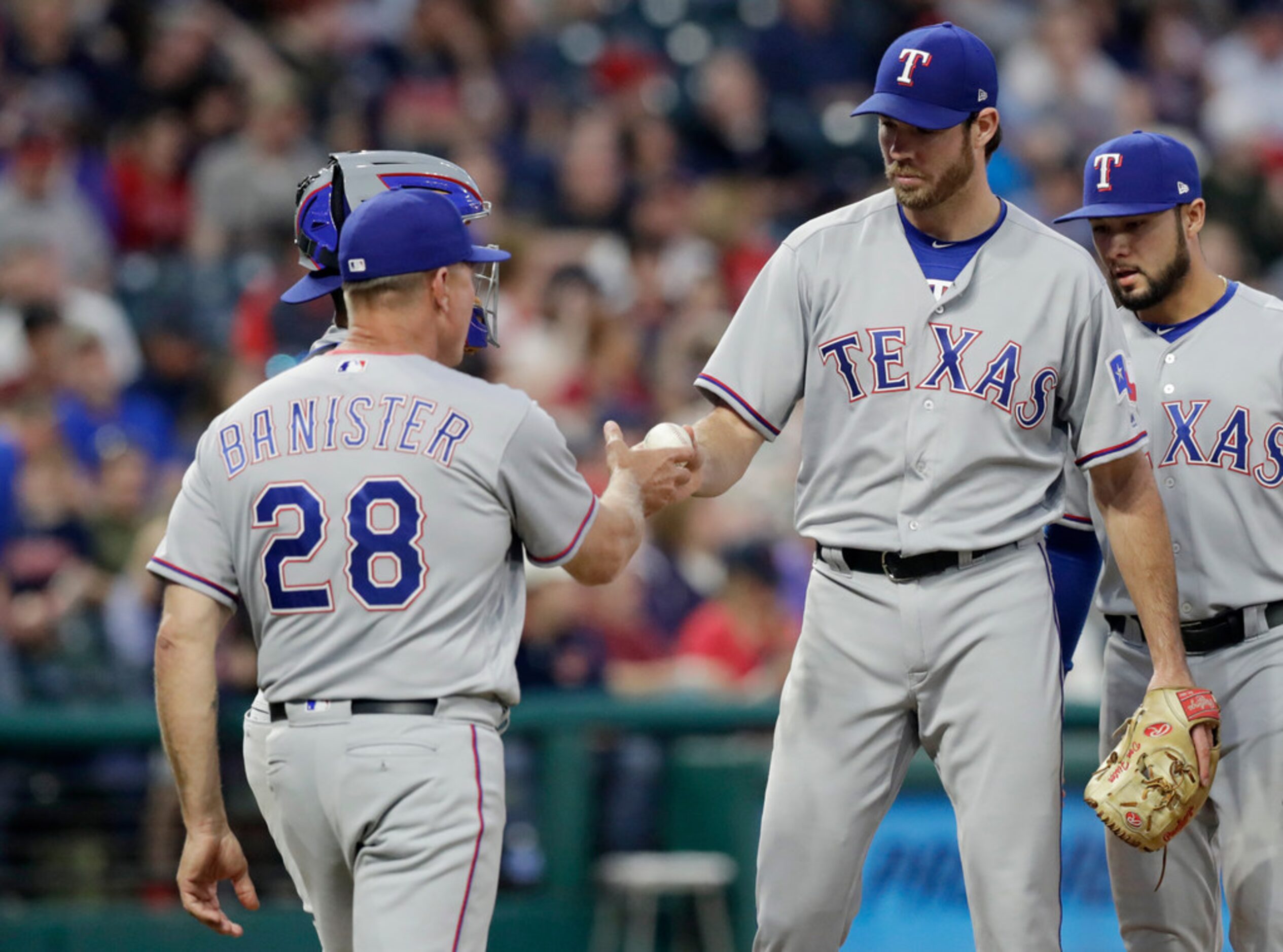 Texas Rangers starting pitcher Doug Fister hands the ball off to Texas Rangers manager Jeff...