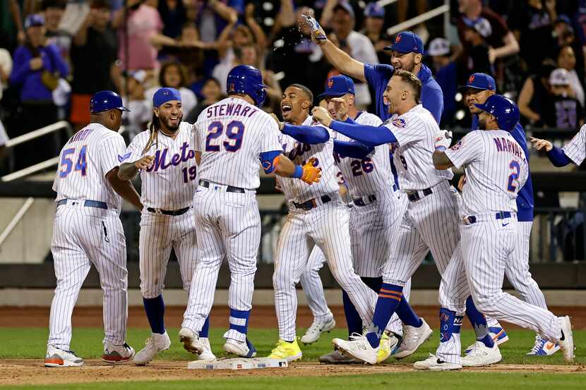 New York Mets' DJ Stewart (29) is congratulated by teammates after he was hit by a pitch...