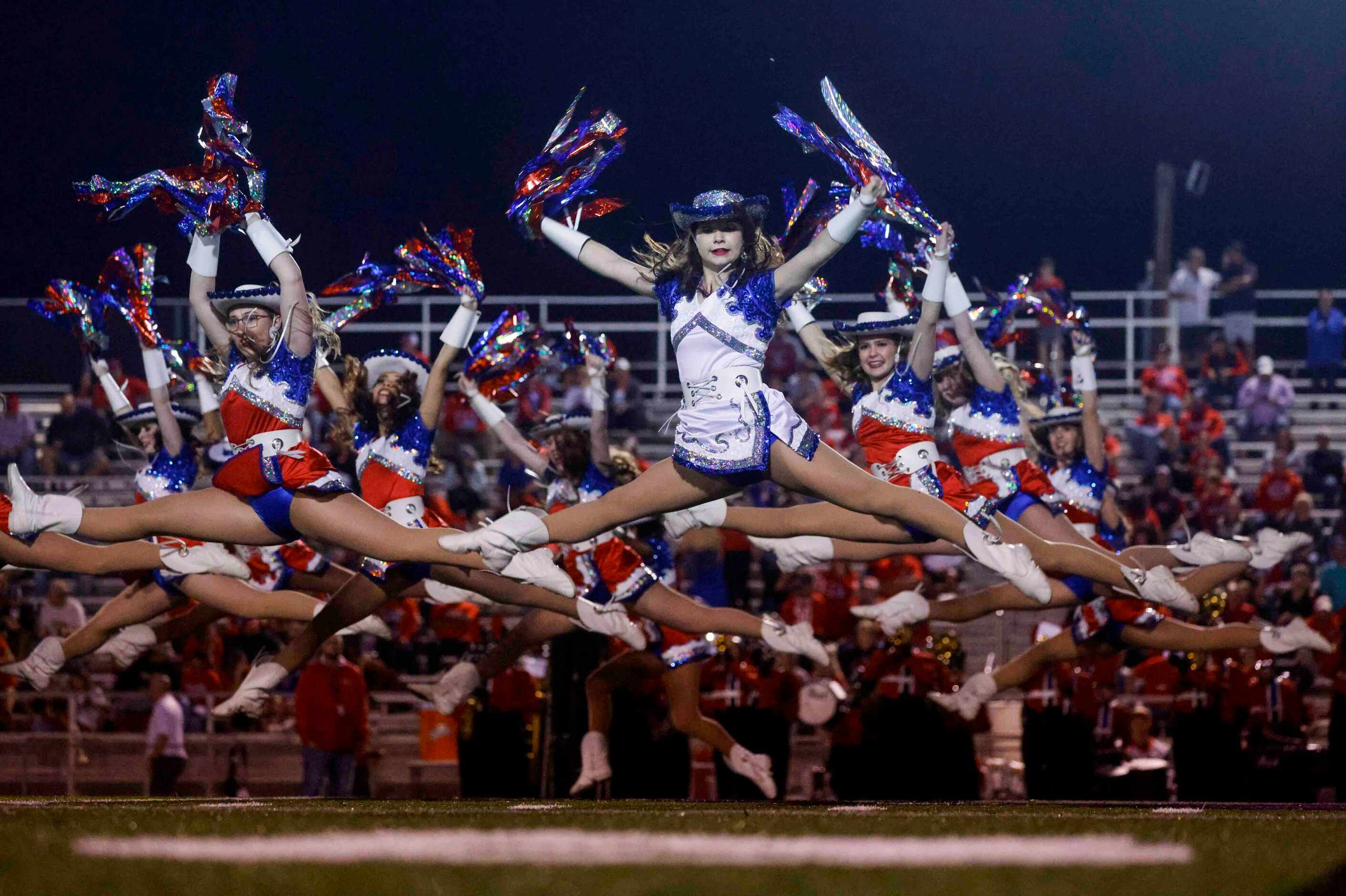 Midlothian Heritage High School Heritage Belles perform during the halftime show of a...