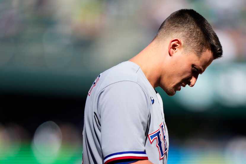 Texas Rangers' Corey Seager looks down after grounding out against the Seattle Mariners...