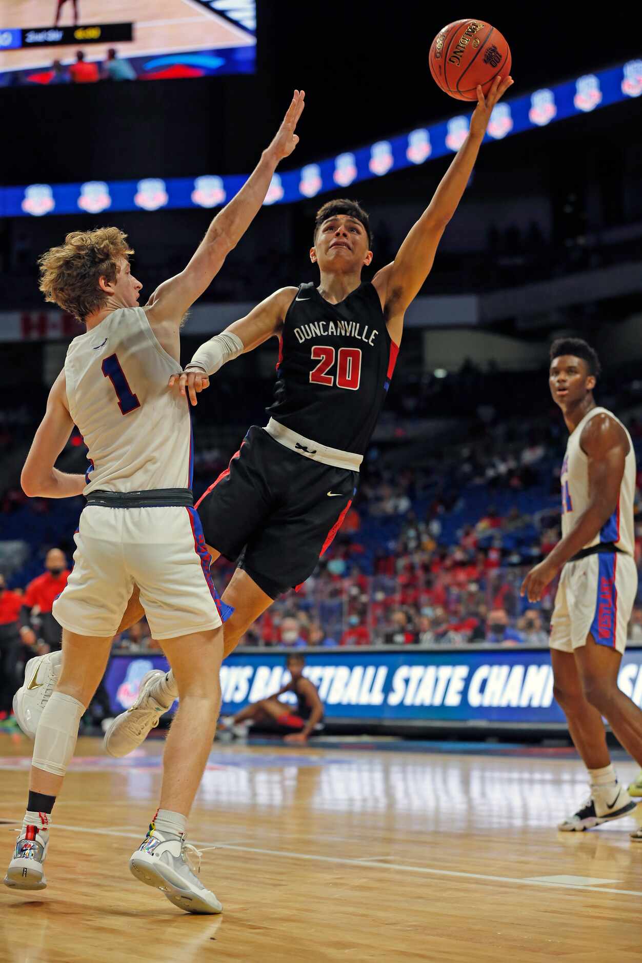 Duncanville Juan Reyna #20 shoots over Westlake Cade Mankle #1. UIL boys Class 6A basketball...