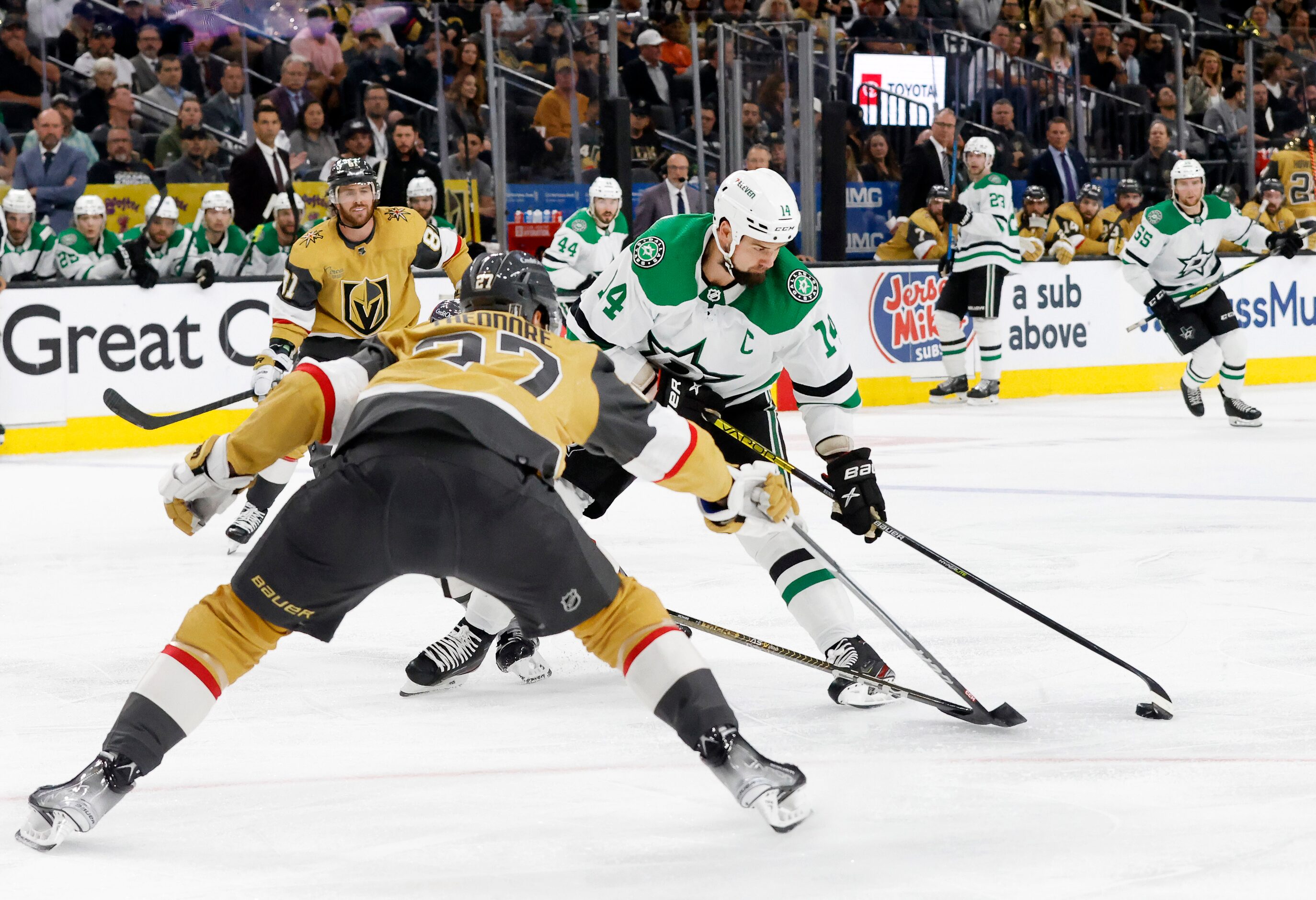 Dallas Stars left wing Jamie Benn (14) looks to shoot as he’s covered by Vegas Golden...