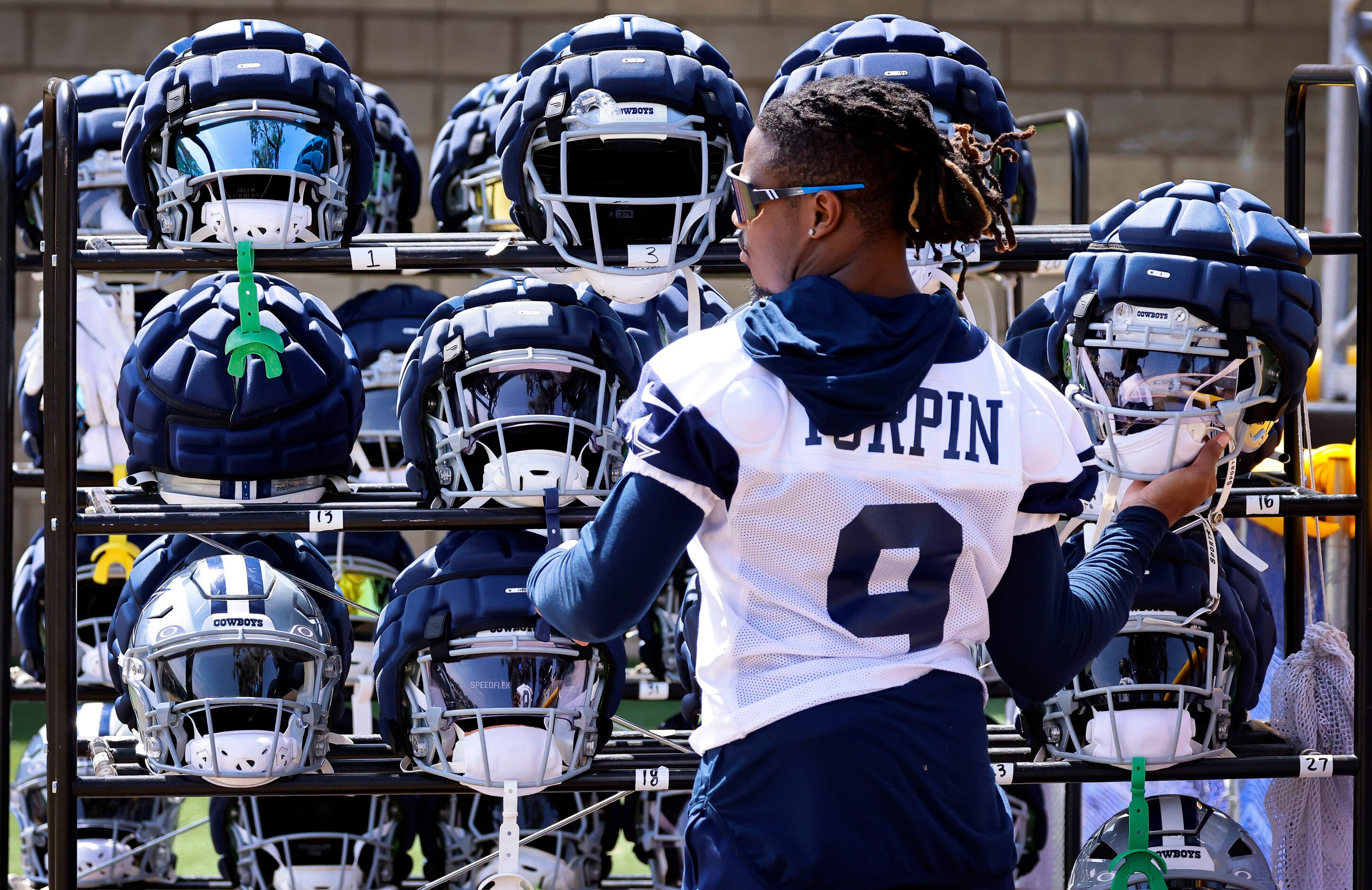 Dallas Cowboys wide receiver KaVontae Turpin (9) grabs his helmet from the rack before...