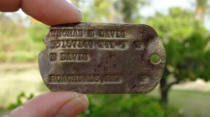  The dog tag worn by Army Pfc. Thomas E. Davis during World War II (Genevieve Cabrera via AP)  