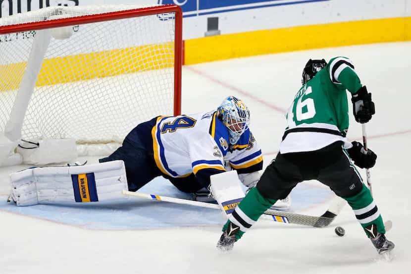 St. Louis Blues goalie Jake Allen (34) dives forward to break up a charge to the net by...