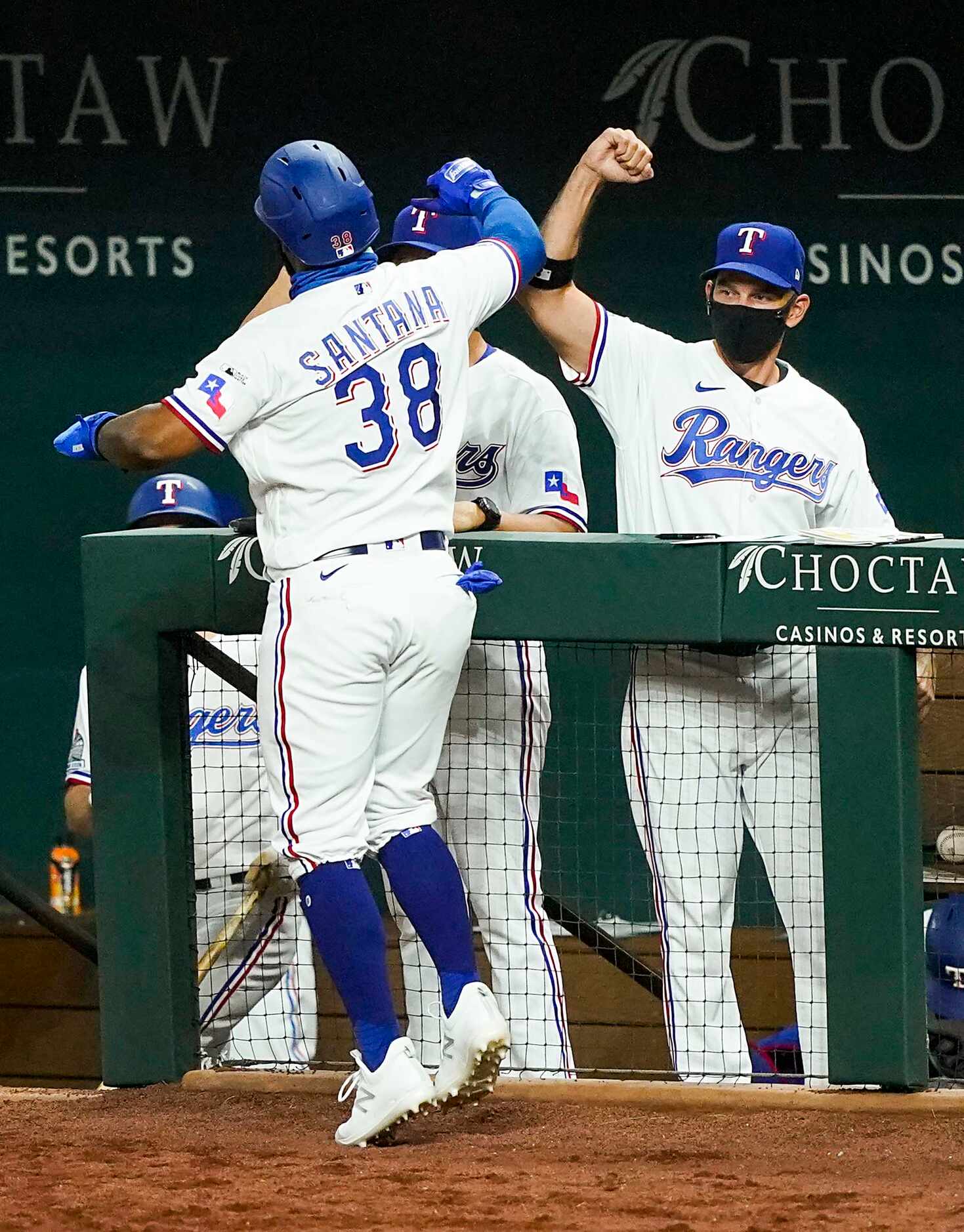Texas Rangers outfielder Danny Santana celebrates with manager Chris Woodward after scoring...