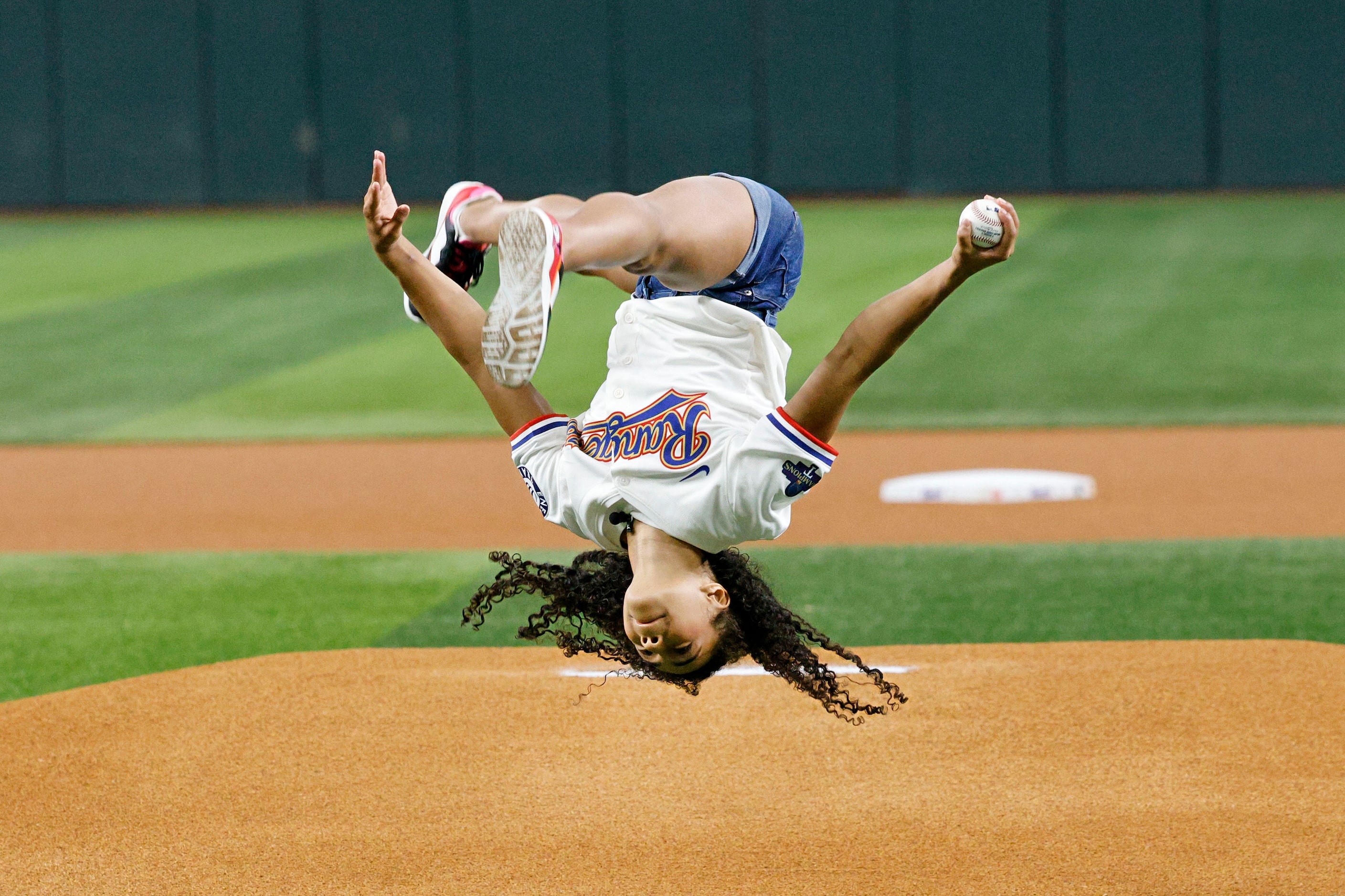 Olympic Gold medalist Hezly Rivera from Plano does a side flip before throwing out a...