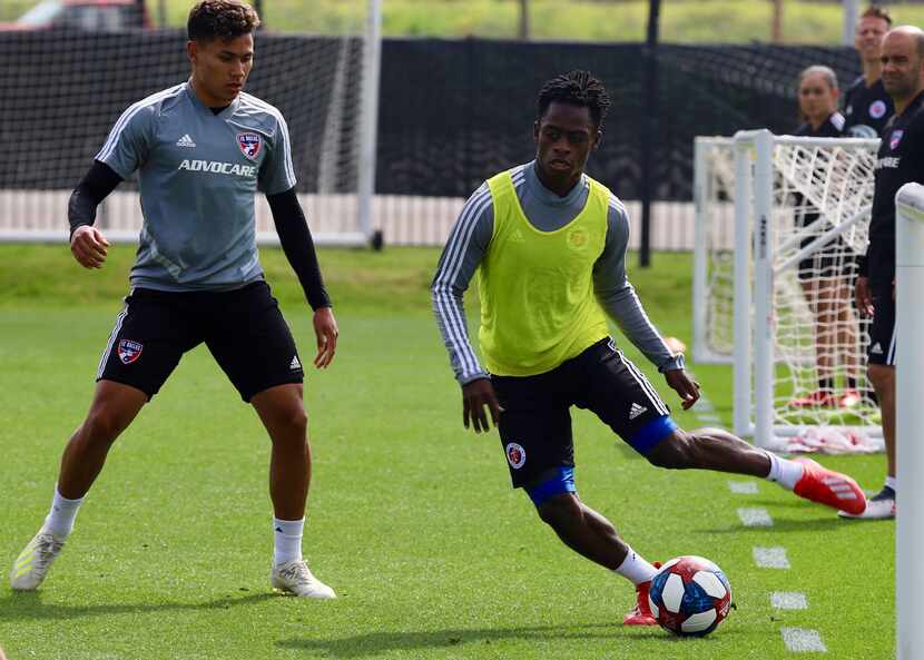 Ronaldo Damus winds up for a pass while marked by Edwin Cerrillo in a combined FC Dallas and...