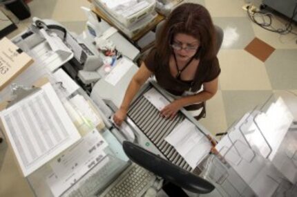  Rosaria Cobarrubias sorts correspondence documents at the Texas Child Support Disbursement...