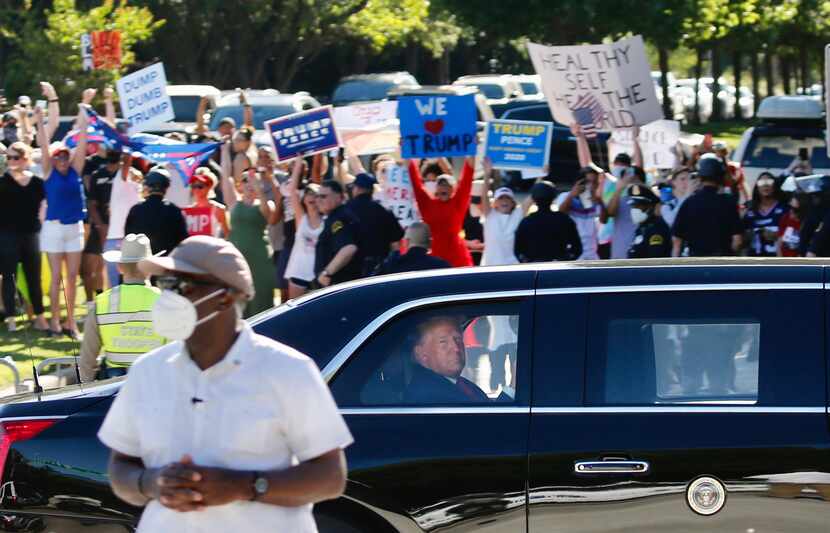 Supporters and detractors lined the road as President Donald Trump rode in the presidential...