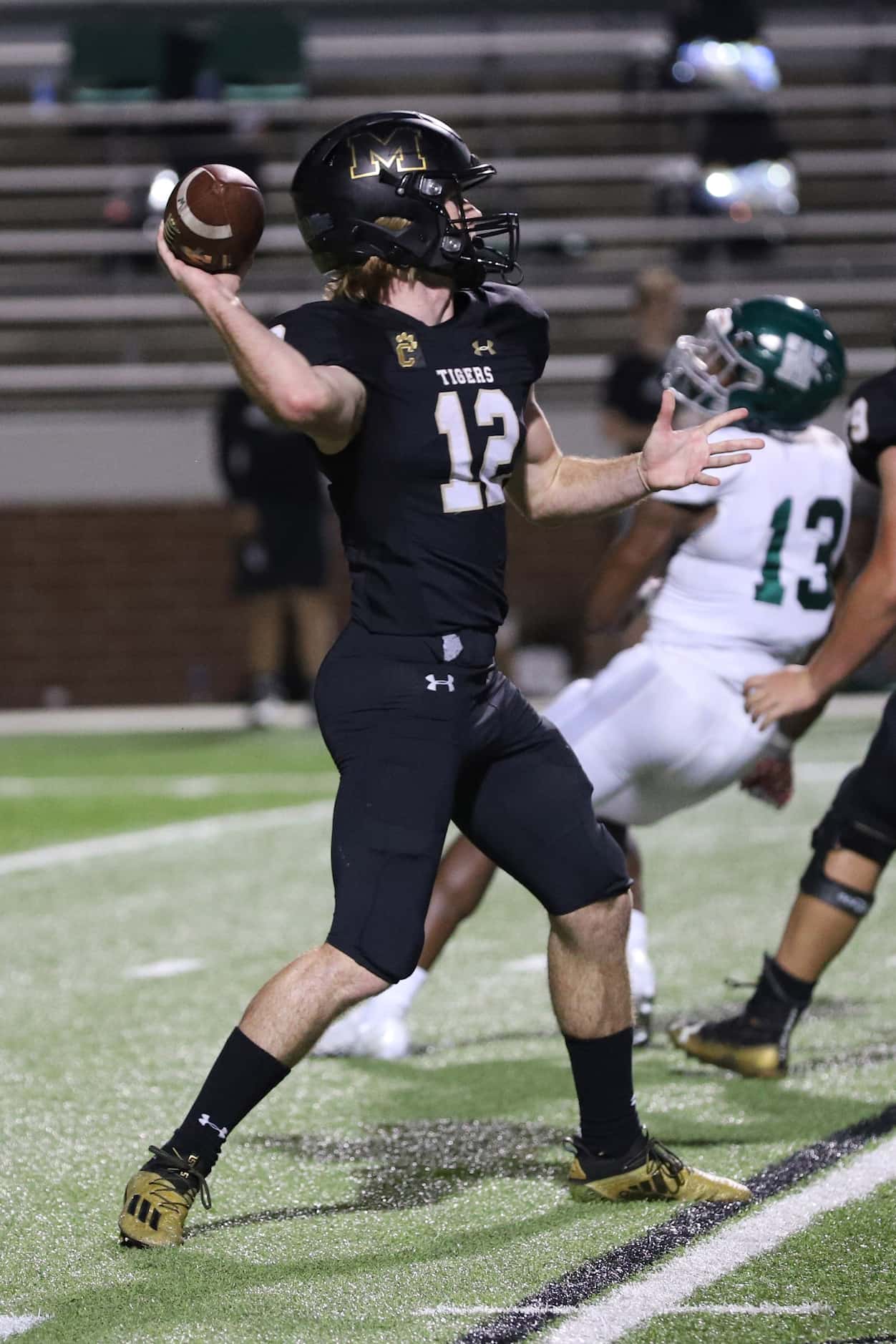 Mansfield quarterback Hunt Young (12) throws a pass during the first half against Waxahachie...