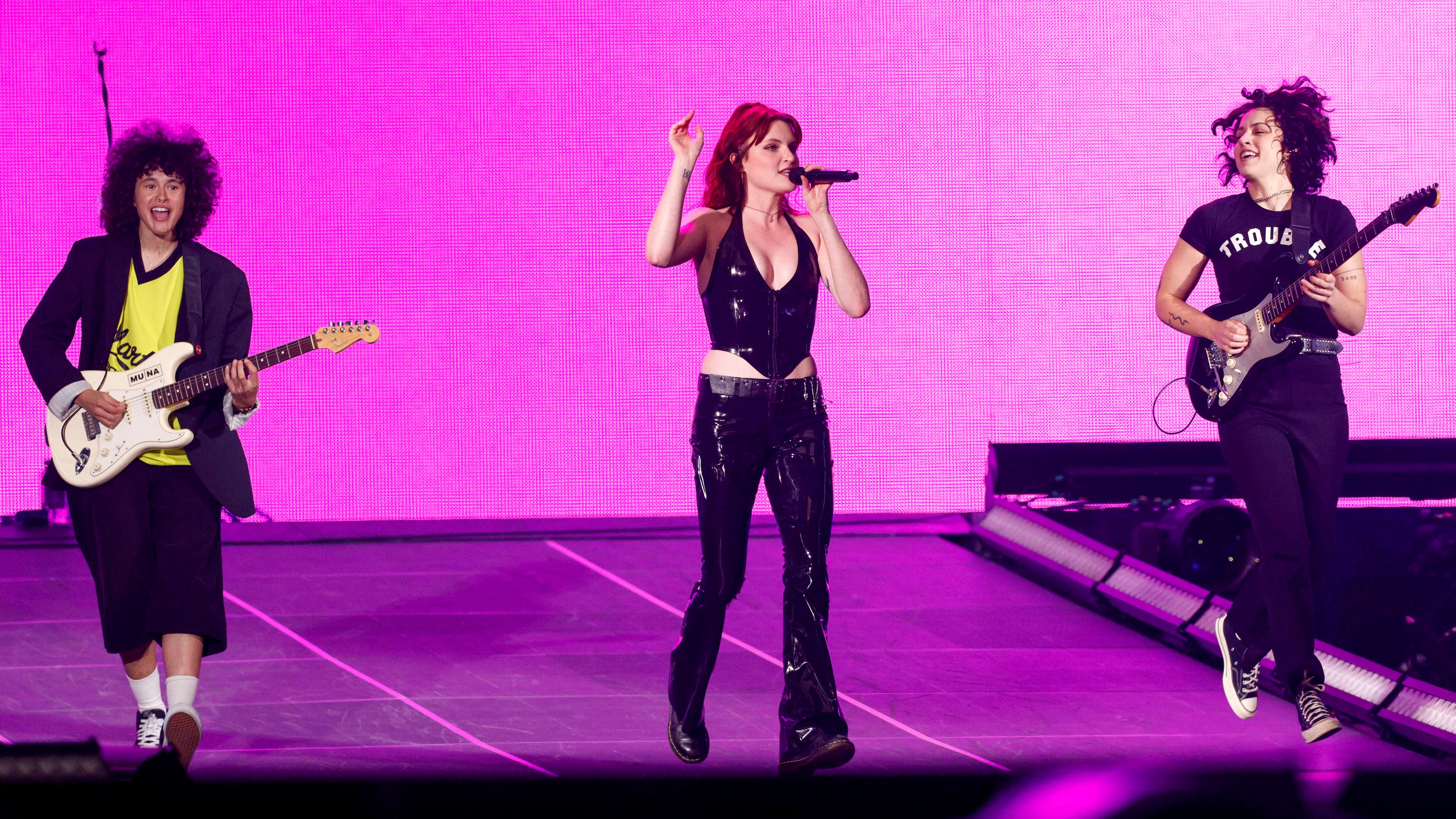 Naomi McPherson (left), Katie Gavin (center) and Josette Maskin of Muna perform onstage at...