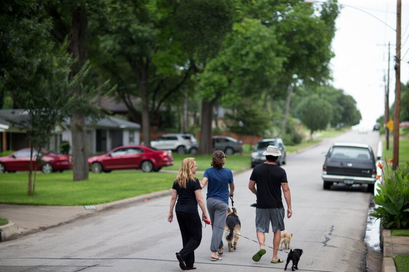 Christina  Martinez (left) walks her dog with her daughter Hana and,  husband Kelly in the...