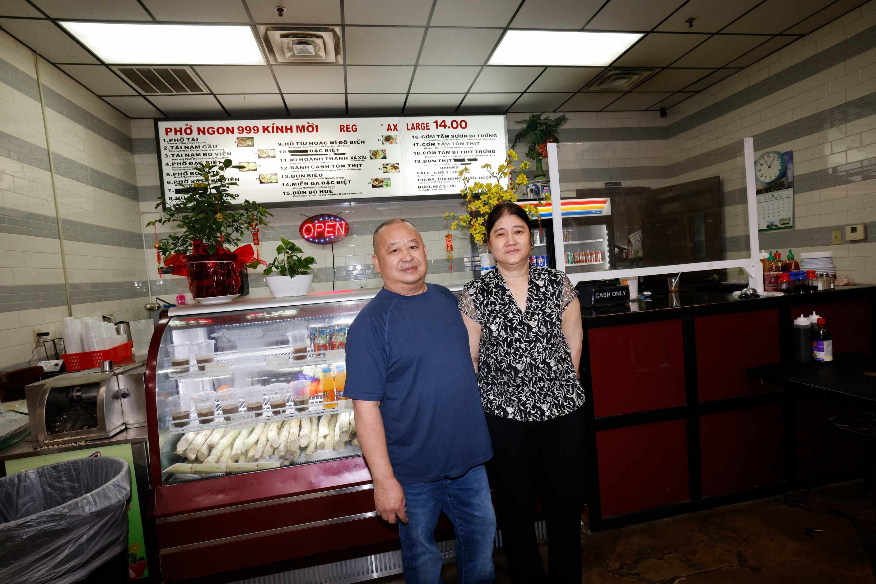 Pho Ngon 999 Manager Khan Pham and his wife Chef Sa Tran pose for a photo in front of their...