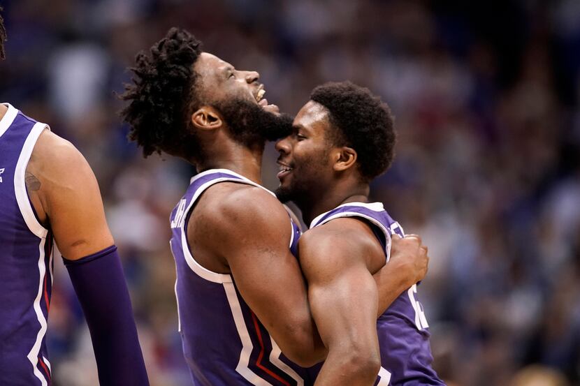 TCU guards Mike Miles Jr., left, and Shahada Wells (13) embrace during a timeout in the...