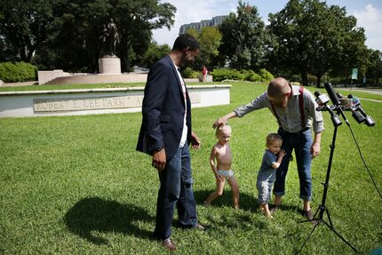 Rev. Dr. Jeff Hood greets his children Jeff Hood Jr., 5, and Quinley Mandela Hood, 3, as he...