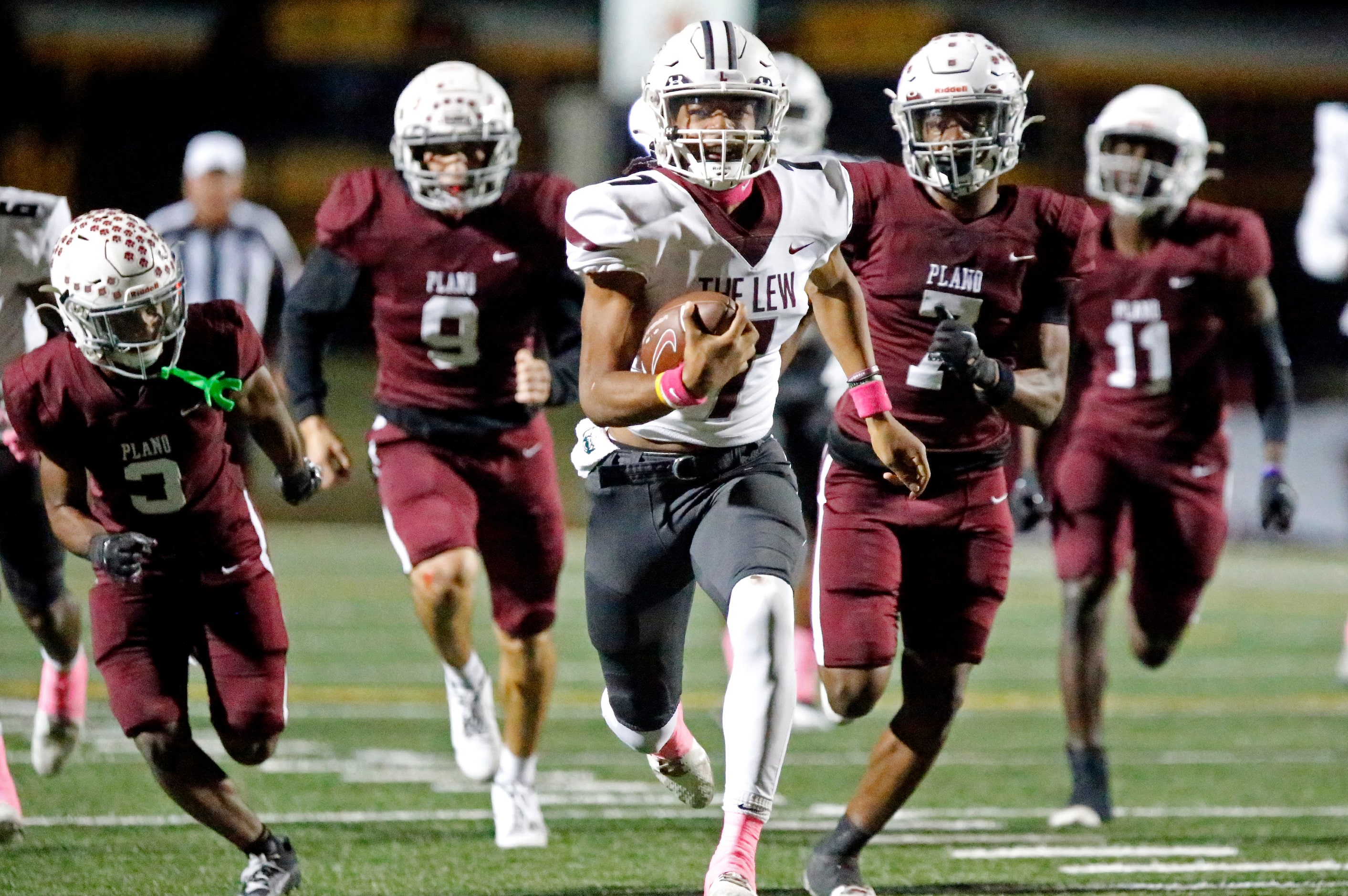 Lewisville High School quarterback Ethan Terrell (7) outruns  the Plano defense for a...