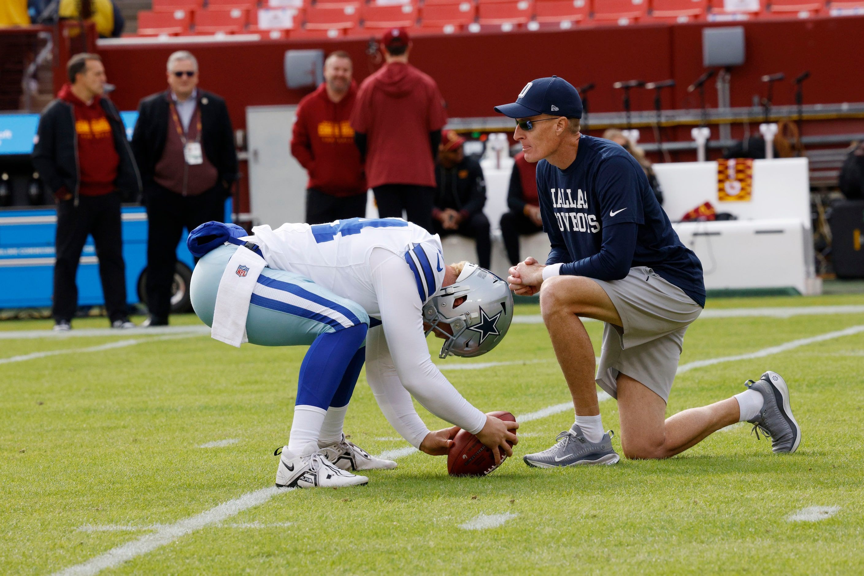 Dallas Cowboys special teams coordinator John Fassel works with Dallas Cowboys long snapper...