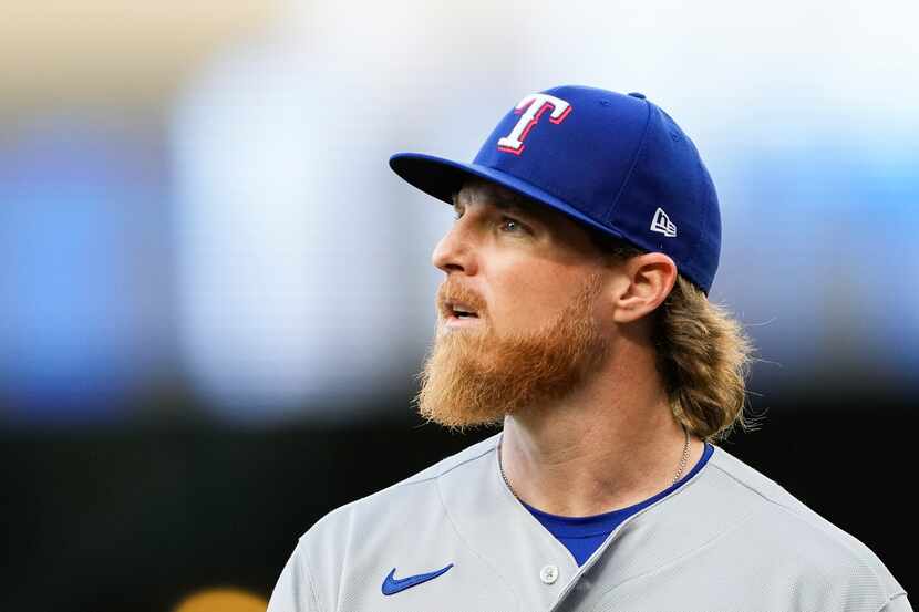 Texas Rangers starting pitcher Jon Gray walks off the field after facing the Seattle...