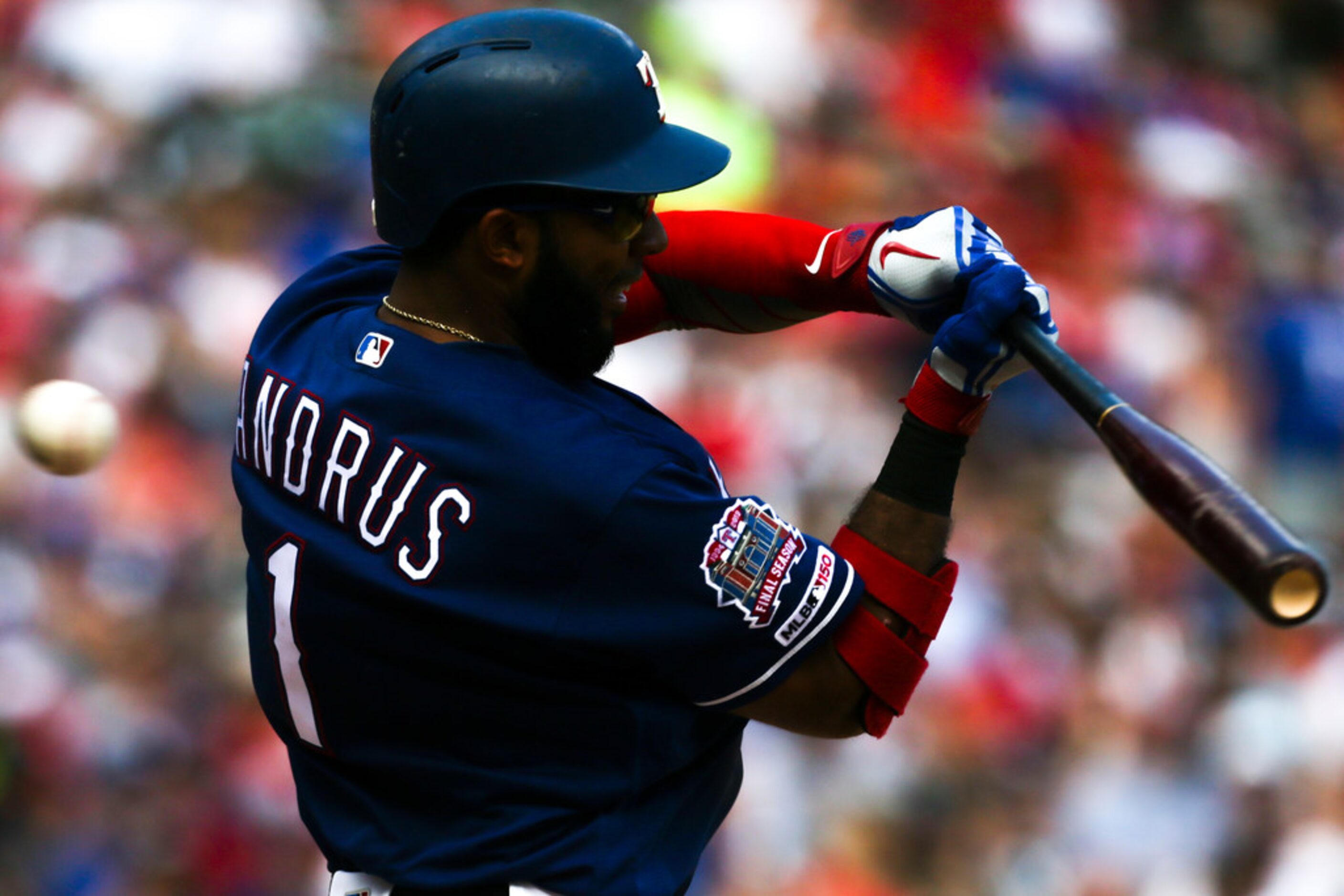 Texas Rangers shortstop Elvis Andrus (1) swings a misses during a MLB game between Texas...