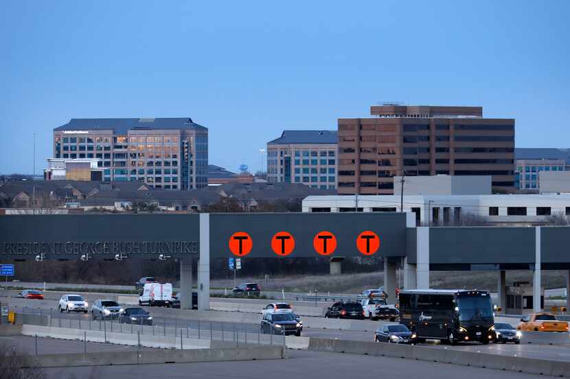 Evening traffic crosses under the President George Bush Turnpike station (NTTA State Highway...