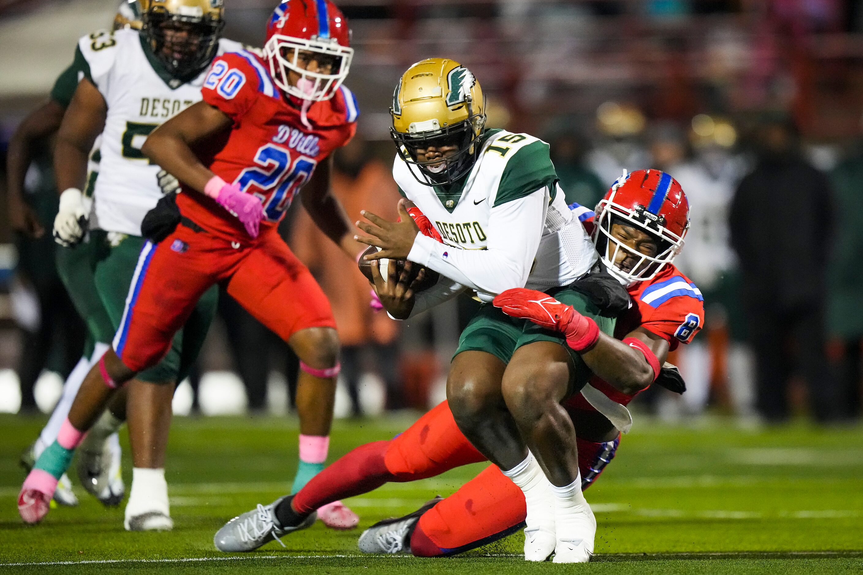 DeSoto quarterback Darius Bailey (15) is brought down by Duncanville linebacker Colin...