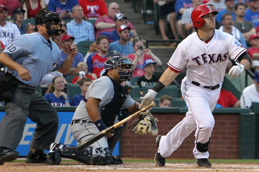 Texas first baseman Mitch Moreland hits a sacrifice fly in the second inning during the...